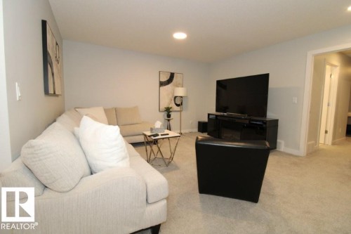 The living area features light-colored carpeting and recessed ceiling lighting - 22140 81 Avenue, Edmonton, AB 