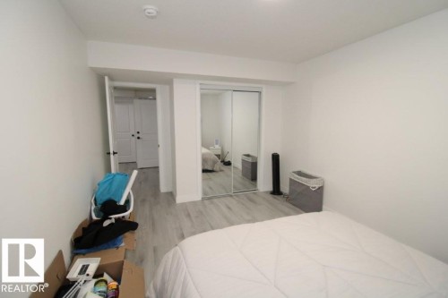 The room features light-colored walls and flooring, with a sliding mirrored closet door - 22140 81 Avenue, Edmonton, AB 