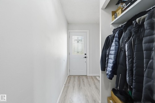 Entryway featuring light-toned flooring and a white front door with decorative glass inserts - 9031 133 Avenue, Edmonton, AB - Indoor Photo Showing Other Room