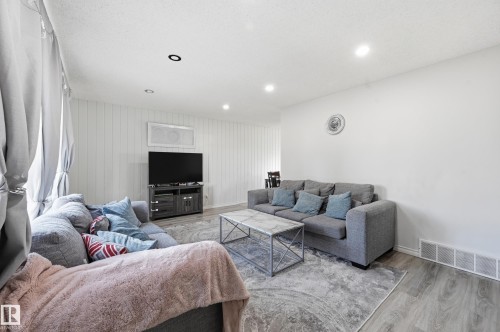 The living area features recessed lighting, light-colored walls, and wood-style flooring - 9031 133 Avenue, Edmonton, AB - Indoor Photo Showing Living Room