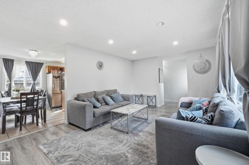 The living area features recessed lighting, light-toned walls, and wood-look flooring, creating a bright and inviting atmosphere - 9031 133 Avenue, Edmonton, AB - Indoor Photo Showing Living Room