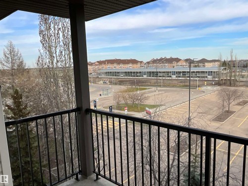 Balcony featuring black metal railings and a textured overhead soffit - 408 309 Clareview Station Drive Nw, Edmonton, AB - Outdoor With Balcony With View