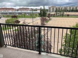 Outdoor balcony featuring a black metal railing and concrete flooring - 