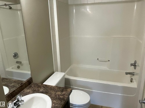 White acrylic tub and shower combination with chrome fixtures - 408 309 Clareview Station Drive Nw, Edmonton, AB - Indoor Photo Showing Bathroom