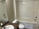 White acrylic tub and shower combination with chrome fixtures - 408 309 Clareview Station Drive Nw, Edmonton, AB  - Indoor Photo Showing Bathroom 