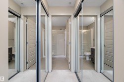 This hallway features mirrored sliding closet doors and light-colored walls - 