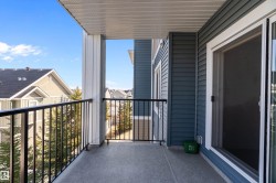 The property features a private balcony with a durable concrete floor, black metal railings, and a sliding glass door for access - 