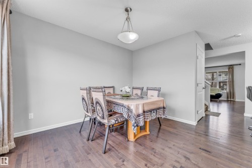 The dining area features hard wood floors and light gray walls - 607 Allard Boulevard, Edmonton, AB - Indoor Photo Showing Dining Room