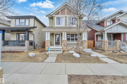 The property features a two-story exterior with light green siding and brown trim - 607 Allard Boulevard, Edmonton, AB - Outdoor With Deck Patio Veranda With Facade