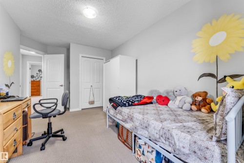 This room features light-colored walls and carpeted flooring, providing a neutral backdrop - 607 Allard Boulevard, Edmonton, AB - Indoor Photo Showing Bedroom