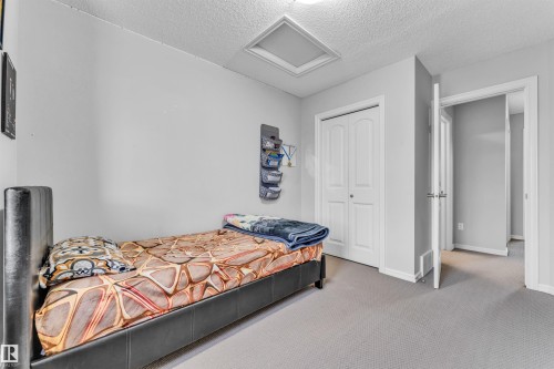 This room features light grey walls and light grey carpet, creating a neutral palette - 607 Allard Boulevard, Edmonton, AB - Indoor Photo Showing Bedroom