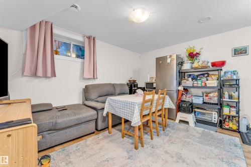 The property features a combined living and dining area with light wood flooring - 607 Allard Boulevard, Edmonton, AB - Indoor