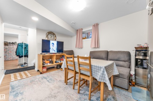 Living area featuring a light-colored rug, wood flooring, and recessed ceiling lighting - 607 Allard Boulevard, Edmonton, AB - Indoor