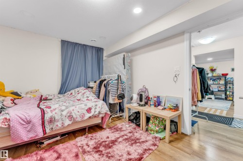 This property features hard flooring, light-colored walls, and recessed lighting - 607 Allard Boulevard, Edmonton, AB - Indoor Photo Showing Bedroom