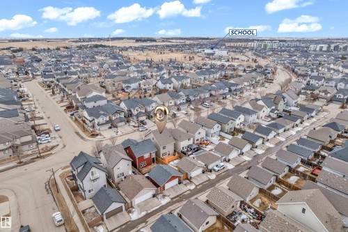 This aerial view showcases the property within a well-developed neighborhood, featuring numerous residential homes with varied rooflines and a visible street network - 607 Allard Boulevard, Edmonton, AB - Outdoor With View