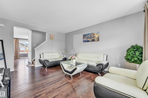Living room featuring rich hardwood flooring, light gray walls, and a white ceiling - 607 Allard Boulevard, Edmonton, AB - Indoor Photo Showing Living Room