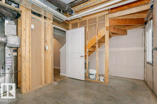 Unfinished space providing an opportunity for customization, featuring exposed wooden framing, a concrete floor, and visible ductwork - 99 320 Secord Boulevard, Edmonton, AB - Indoor Photo Showing Basement