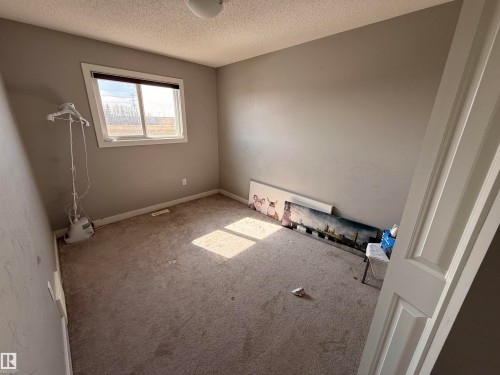 The room features a window with natural light, neutral-toned walls, and carpeted flooring - 3317 11 Avenue, Edmonton, AB - Indoor Photo Showing Other Room