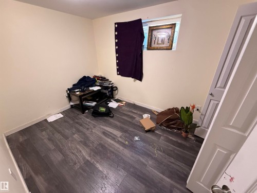 The room features light-colored walls and dark wood-look flooring - 3317 11 Avenue, Edmonton, AB - Indoor Photo Showing Other Room