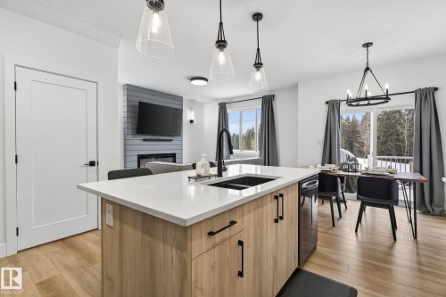 127 Hilton Cove, Spruce Grove, AB - Indoor Photo Showing Kitchen With Fireplace With Double Sink