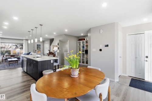 The property features an open-concept layout with light-colored flooring throughout - 4750 Crabapple Run, Edmonton, AB - Indoor Photo Showing Dining Room