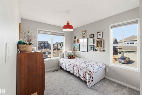 This room features light grey walls and light grey carpet - 4750 Crabapple Run, Edmonton, AB - Indoor Photo Showing Bedroom