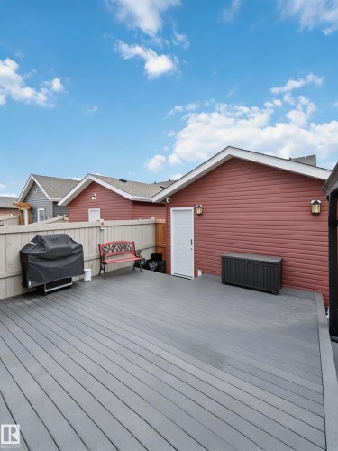 The property features an outdoor deck with grey decking boards - 4750 Crabapple Run, Edmonton, AB - Outdoor With Deck Patio Veranda With Exterior