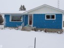 The property features blue horizontal siding with white trim and a concrete foundation - 4315 56 Avenue, Barrhead, AB  - Outdoor 