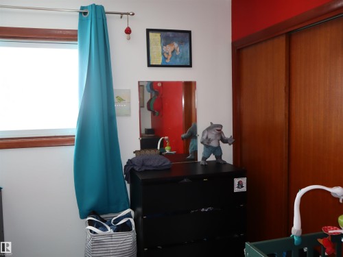 This room features a window with a curtain rod and a teal curtain - 4315 56 Avenue, Barrhead, AB - Indoor