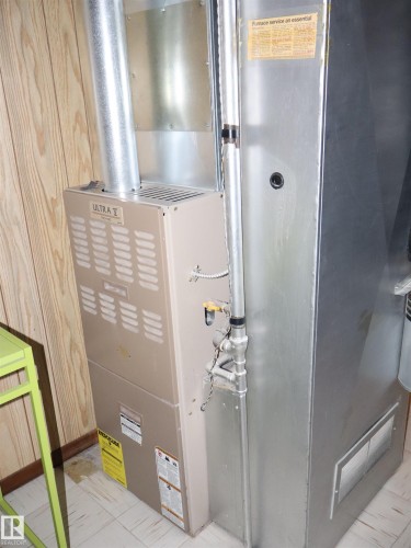 The property is equipped with a furnace system, visible with metal ductwork and piping - 4315 56 Avenue, Barrhead, AB - Indoor Photo Showing Basement