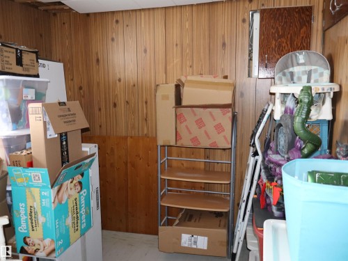 This room features wood paneling on the walls and a white ceiling - 4315 56 Avenue, Barrhead, AB - Indoor
