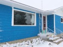 The property features a bold blue exterior with white trim and white gutters - 4315 56 Avenue, Barrhead, AB  - Outdoor 
