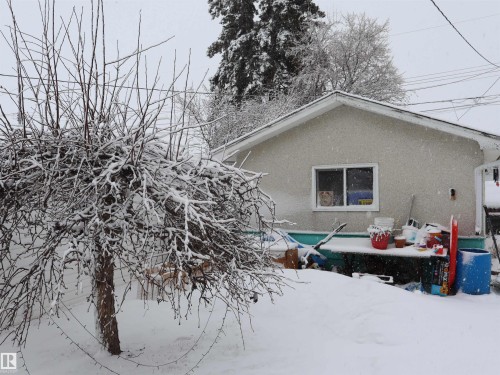 The property features a stucco exterior, a sloped roof, and a visible window - 4315 56 Avenue, Barrhead, AB - Outdoor