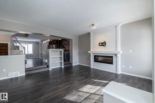 6938 23 Avenue, Edmonton, AB - Indoor Photo Showing Living Room With Fireplace