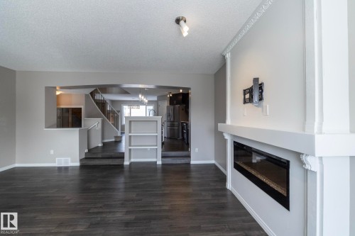6938 23 Avenue, Edmonton, AB - Indoor Photo Showing Living Room With Fireplace