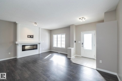 6938 23 Avenue, Edmonton, AB - Indoor Photo Showing Living Room With Fireplace