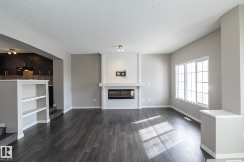 6938 23 Avenue, Edmonton, AB - Indoor Photo Showing Living Room With Fireplace