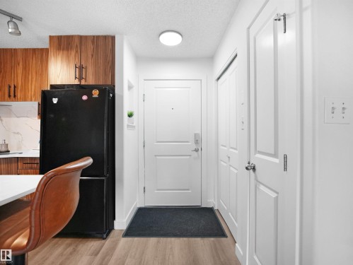 Entryway featuring a white door, light fixture, and light-toned flooring - 106 2305 35A Avenue Nw, Edmonton, AB - Indoor Photo Showing Other Room