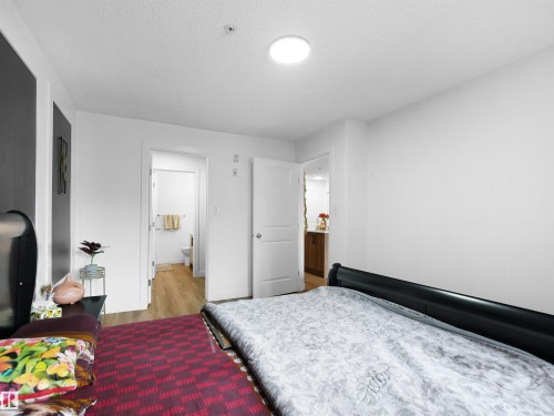 Well-lit room with white walls, a ceiling light fixture, and light-colored flooring - 106 2305 35A Avenue Nw, Edmonton, AB - Indoor Photo Showing Bedroom