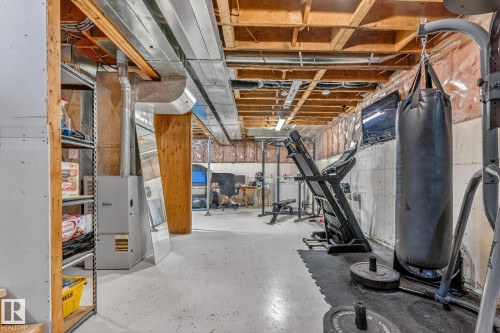 The property features an unfinished basement with exposed wooden joists and ductwork, providing significant potential for customization - 160068 Twp 531, Rural Lamont County, AB - Indoor Photo Showing Basement