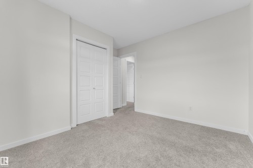This room features light-colored walls and grey carpet flooring - 4416 6 Street, Edmonton, AB - Indoor Photo Showing Other Room