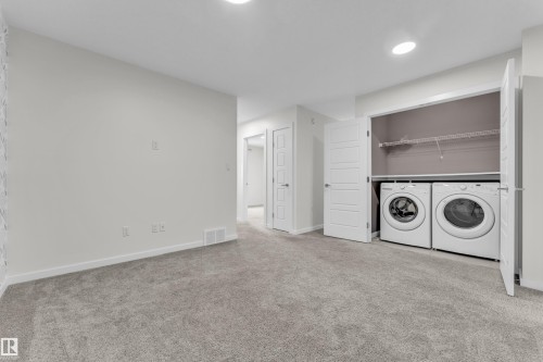 This room features neutral-toned carpet flooring, white walls, and recessed lighting - 4416 6 Street, Edmonton, AB - Indoor Photo Showing Laundry Room