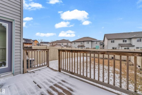 The property features a private deck with wooden railings, leading to a fenced yard - 4416 6 Street, Edmonton, AB - Outdoor