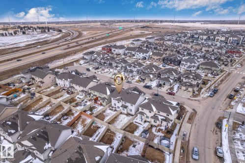 Aerial view of the property and surrounding neighborhood, featuring residential homes, paved roads, and a nearby highway - 4416 6 Street, Edmonton, AB - Outdoor With View