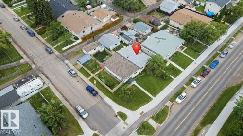 This property features a spacious yard with a lawn offering ample outdoor space - 5920 132 Avenue, Edmonton, AB - Other