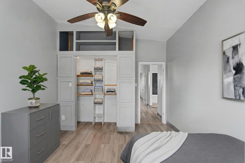 This room features light grey walls, light wood-style flooring, and a ceiling fan with integrated lighting - 5920 132 Avenue, Edmonton, AB - Indoor Photo Showing Bedroom