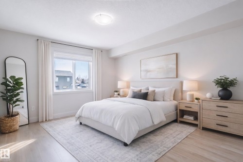 This property features a bright and spacious room with light-toned flooring, a window providing natural light, and a ceiling light fixture. Virtually staged to show how large the Master is! - 209 14612 125 Street, Edmonton, AB - Indoor Photo Showing Bedroom
