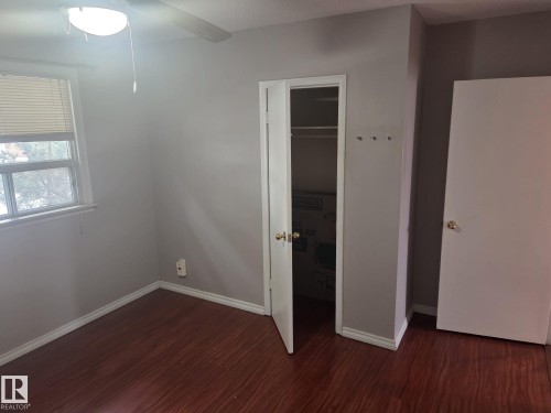 This room features wood-look flooring, light grey walls, and a window with blinds - 3626 111 Avenue, Edmonton, AB - Indoor Photo Showing Other Room