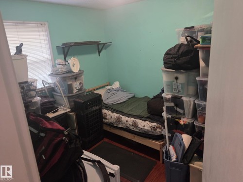 This room features light teal walls, a window with blinds, and wood flooring - 3626 111 Avenue, Edmonton, AB - Indoor