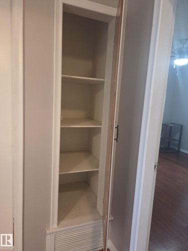 Built-in shelving unit with several shelves and a louvered base - 3626 111 Avenue, Edmonton, AB - Indoor